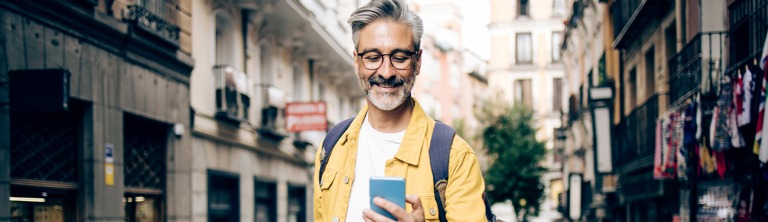 Contact 1000 Mile Travel Vacations - man looking at mobile phone